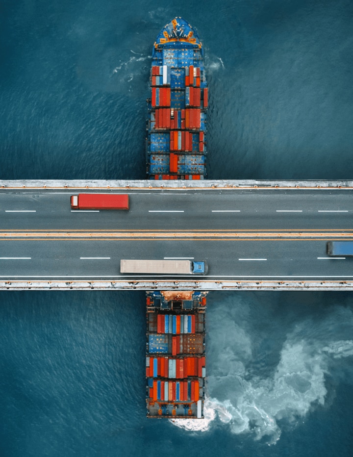 Shipping Containers on a Boat Crossing Under a Highway